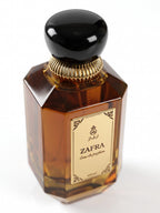 ZAFRA Eau de parfum 100 ml, sticlă maro / ambră — detaliu etichetă și capac
